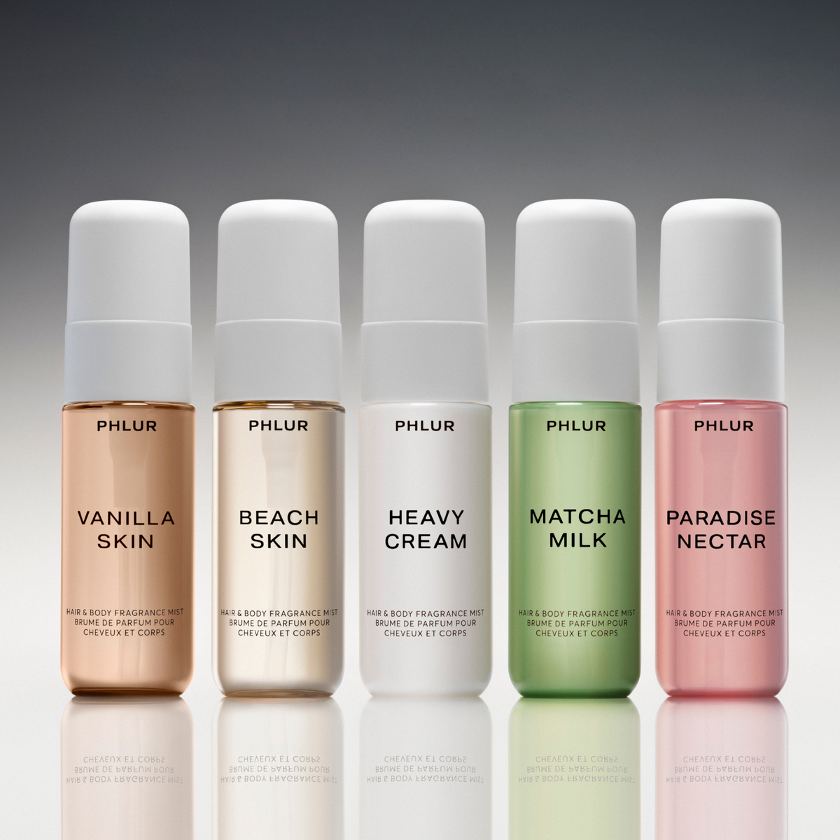 Close-up of the five PHLUR 1 Fl Oz body mists in The Body Mist Edit lined up on a reflective surface